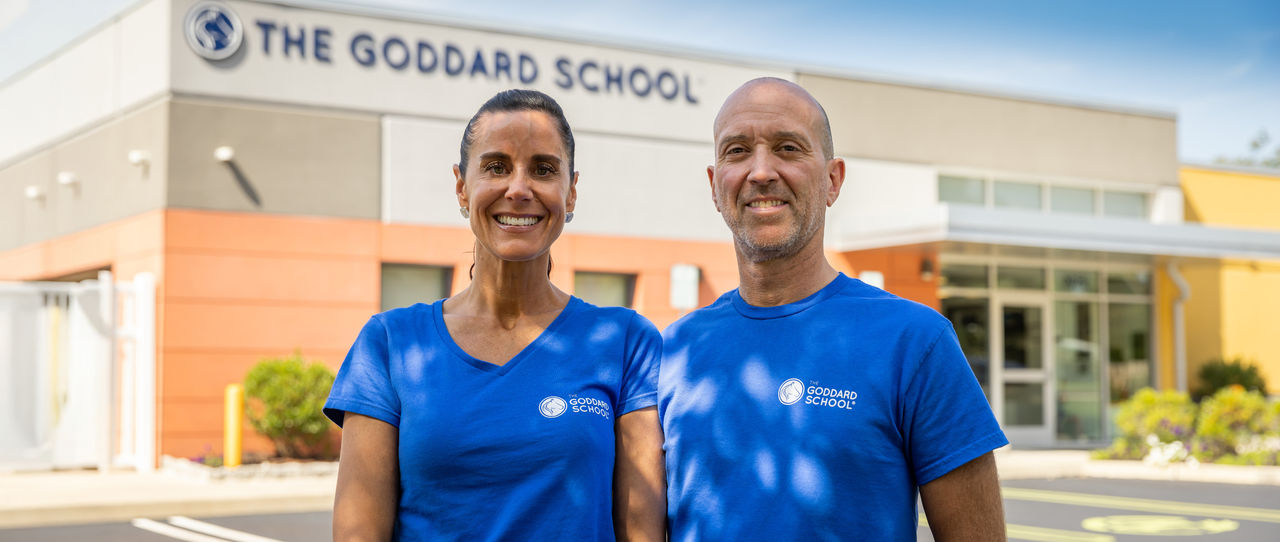 Image of franchisees standing outside their Goddard School 