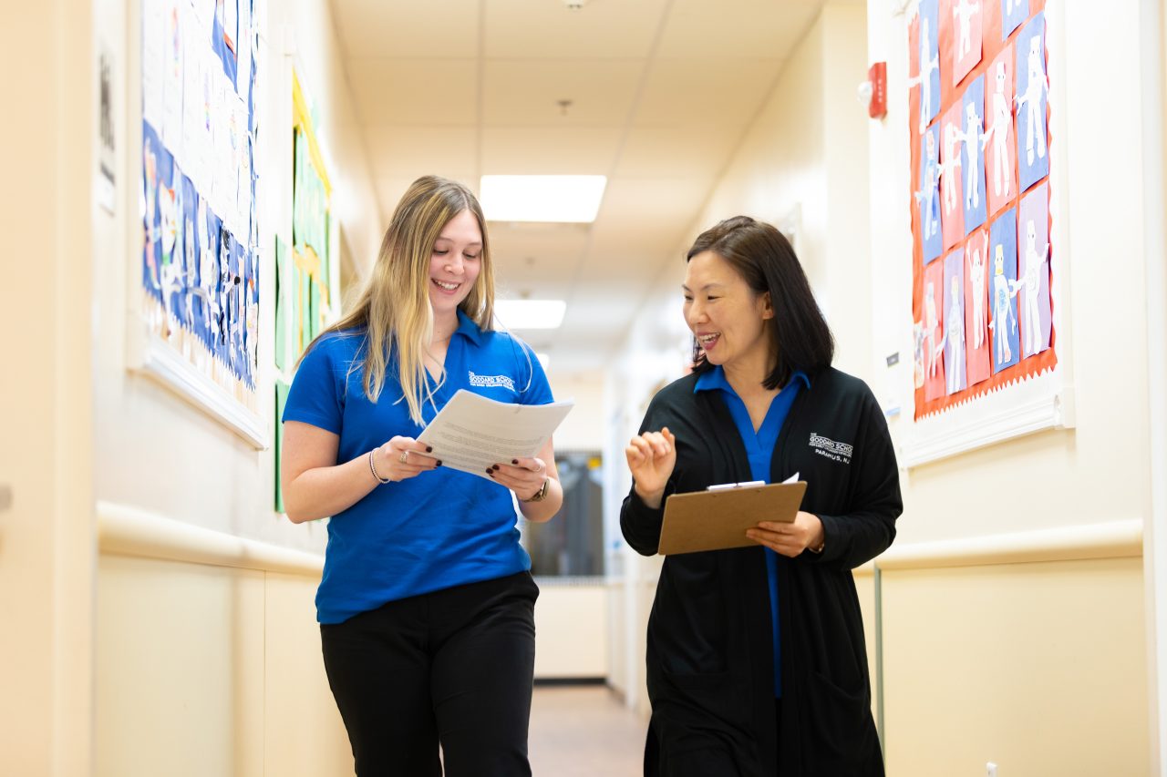 Image of franchisee and faculty walking down hallway