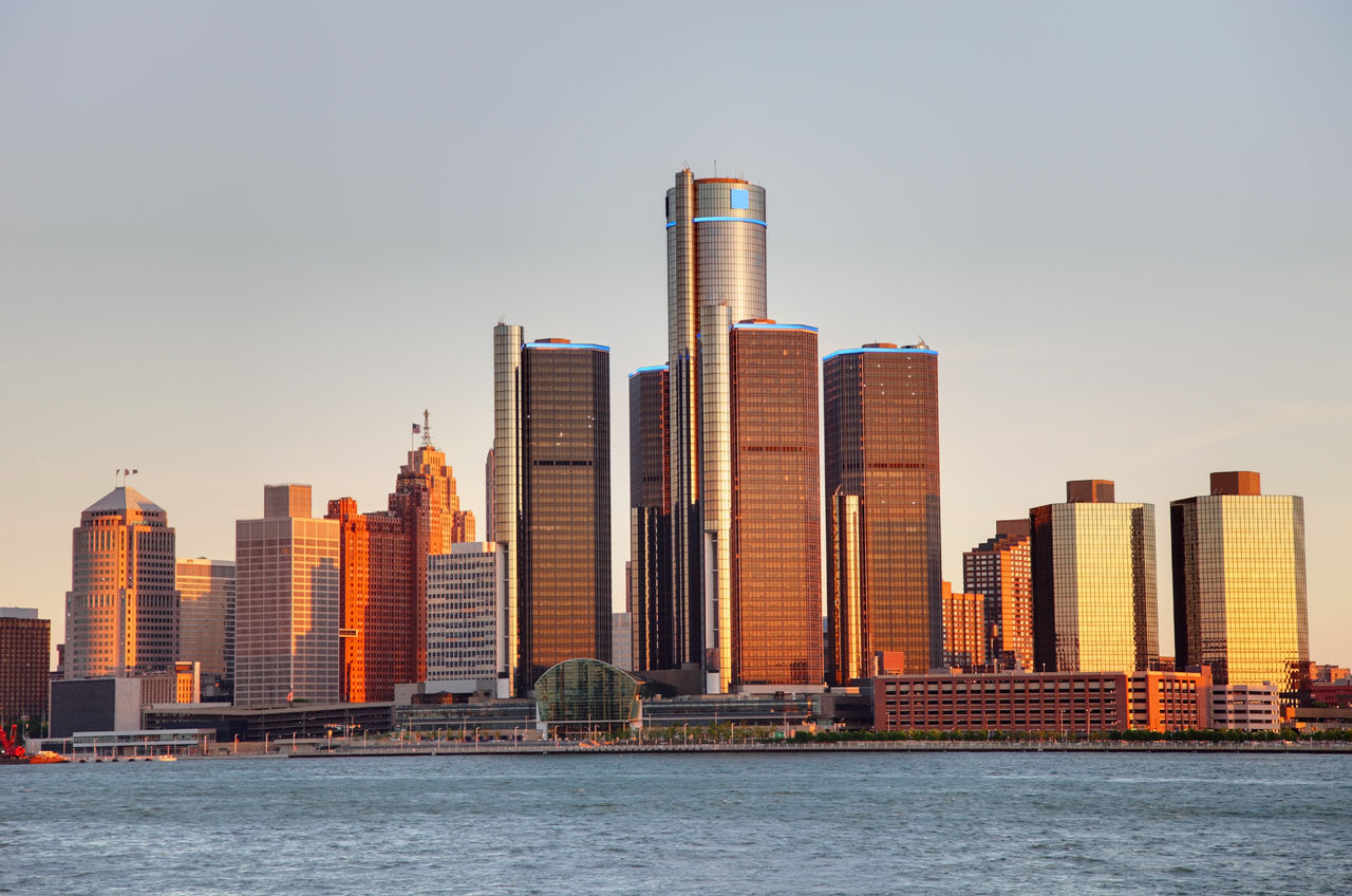 Image of the Detroit city skyline along the Detroit River at dusk.